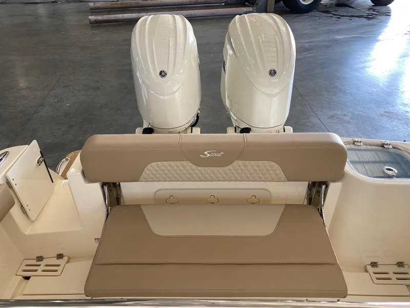 Slide: The Image of 2025 Scout 260 LXF boat with dual engines and beige seating. - 19