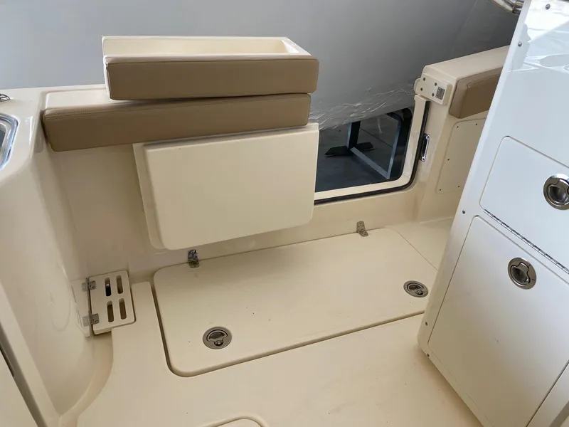 Slide: The Image of 2025 Scout 260 LXF boat interior with beige seating and storage compartments. - 21