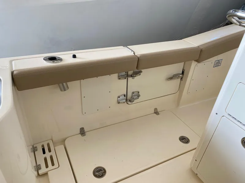Slide: The Image of 2025 Scout 260 LXF boat interior with beige seating and storage compartments. - 22