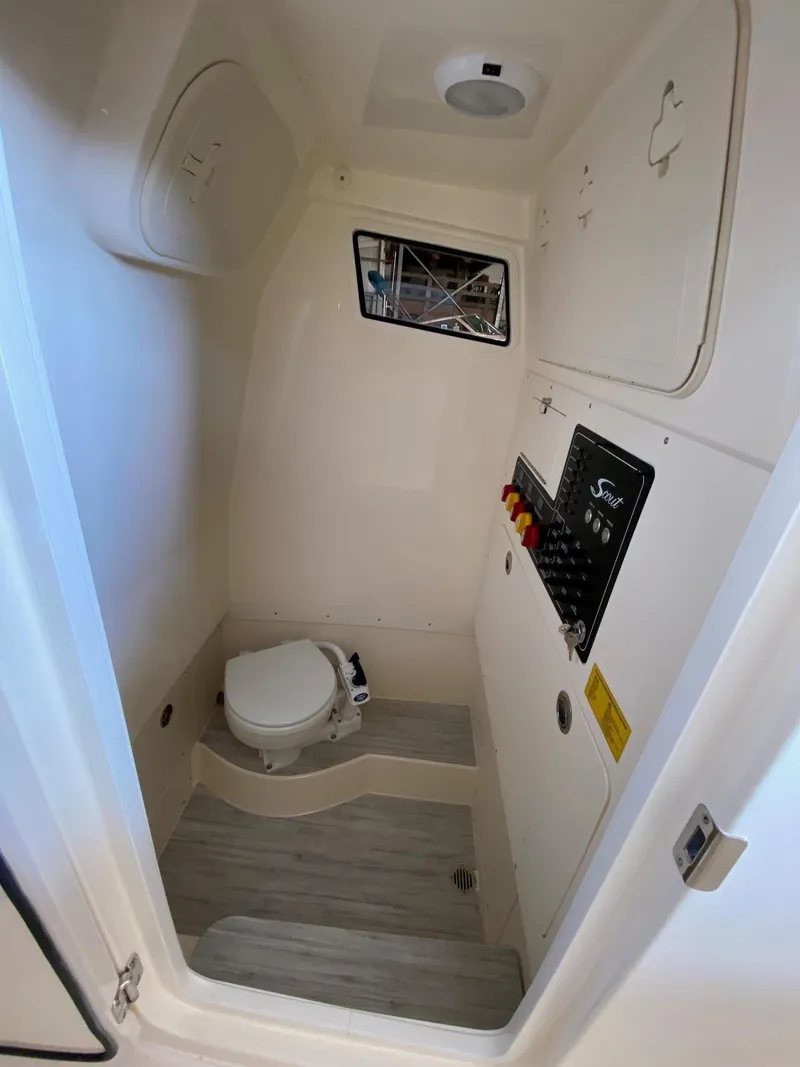 Slide: The Image of 2025 Scout 260 LXF boat interior with toilet and control panel. - 23