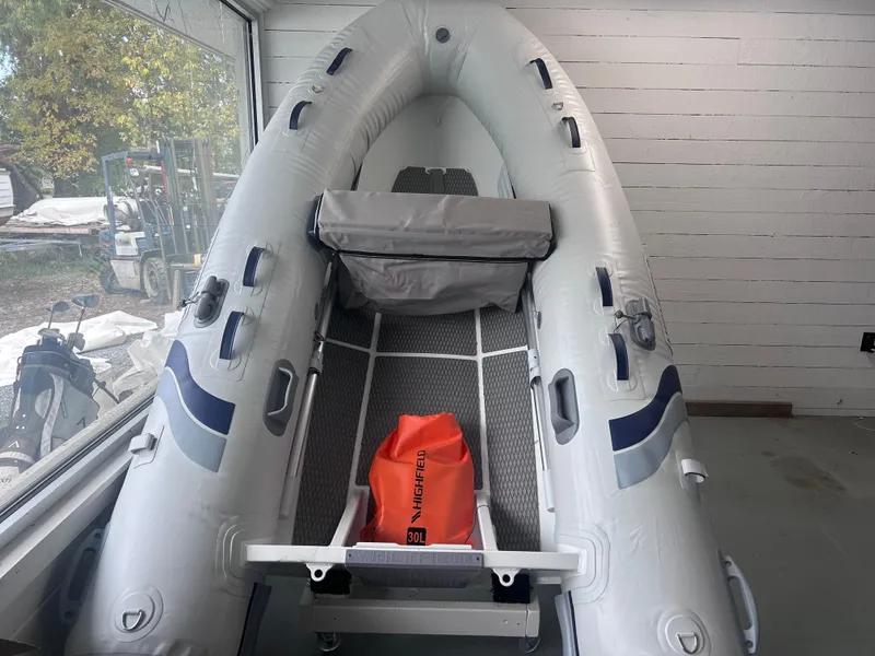 Slide: The Image of 2024 Highfield Ultralite 310 inflatable boat in showroom, featuring a compact design. - 1