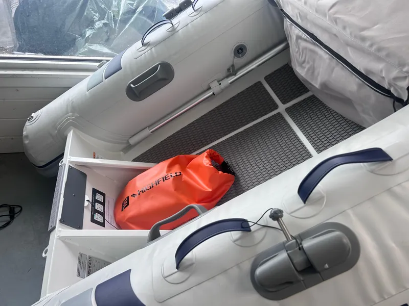 Slide: The Image of 2024 Highfield Ultralite 310 inflatable boat interior with orange dry bag. - 2