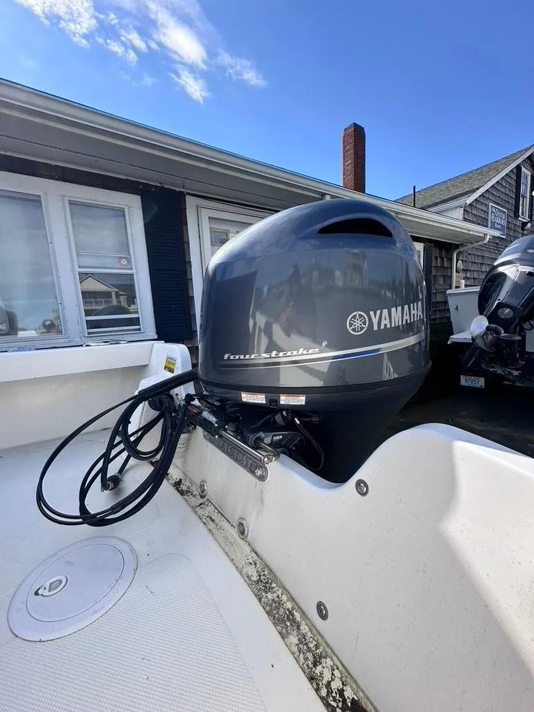 Slide: The Image of 2019 Seaway 18 Sportsman with Yamaha outboard motor in residential setting. - 2