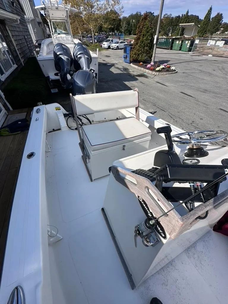 Slide: The Image of 2019 Seaway 18 Sportsman boat with dual outboard motors, docked in a marina. - 4