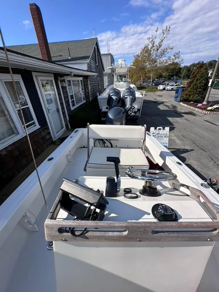 Slide: The Image of 2019 Seaway 18 Sportsman boat with equipment, docked near coastal buildings. - 5