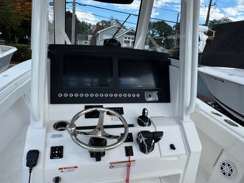 Slide: The Image of 2025 Regulator 31 boat dashboard with steering wheel and control panel. - 11