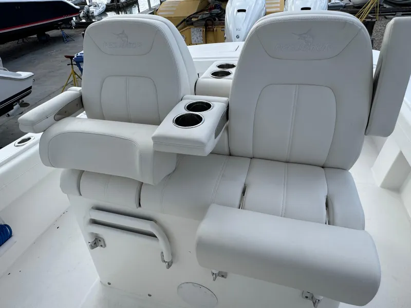 Slide: The Image of 2025 Regulator 31 boat seats with armrests and cup holders. - 12