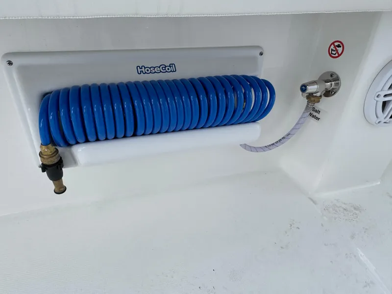 Slide: The Image of Blue coiled hose on 2025 Regulator 31 boat, featuring HoseCoil system. - 13