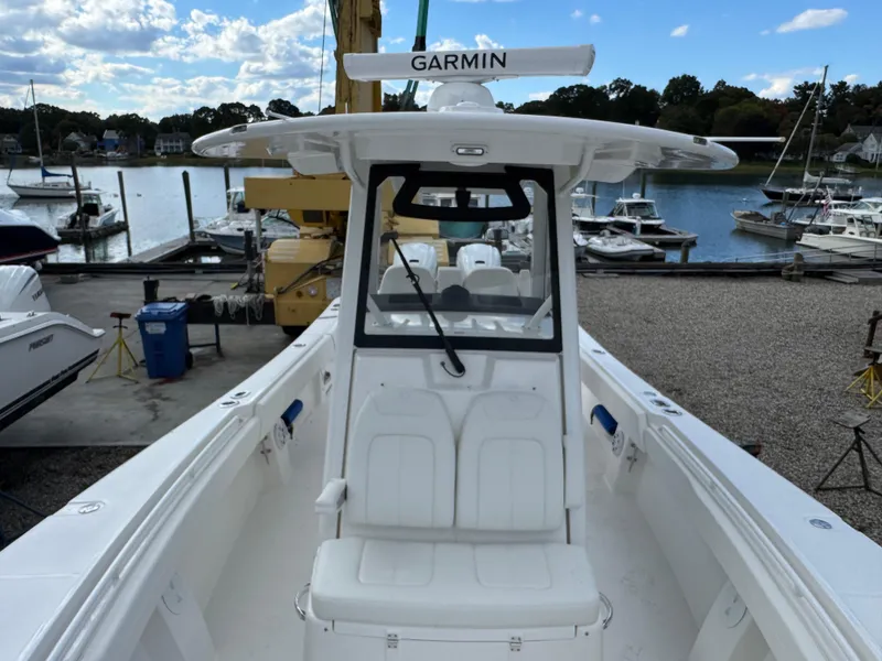 Slide: The Image of 2025 Regulator 31 boat with Garmin equipment, docked at a marina under a partly cloudy sky. - 18