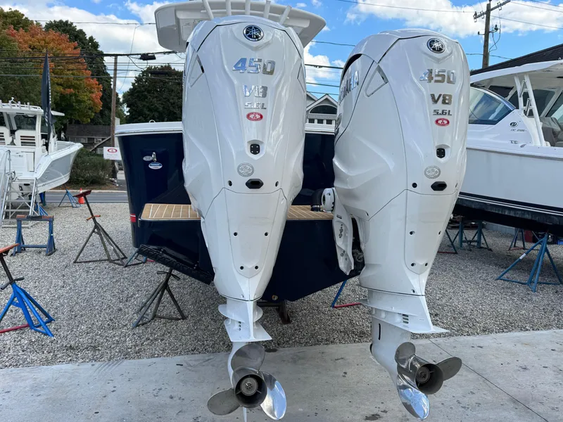 Slide: The Image of 2025 Regulator 31 boat with twin 450 V8 outboard engines displayed on stands. - 2