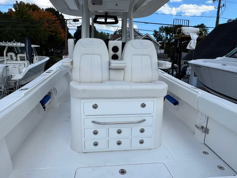 Slide: The Image of 2025 Regulator 31 boat interior with white seating and storage drawers. - 5