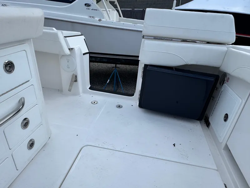 Slide: The Image of 2025 Regulator 31 boat interior with white seating and storage compartments. - 6