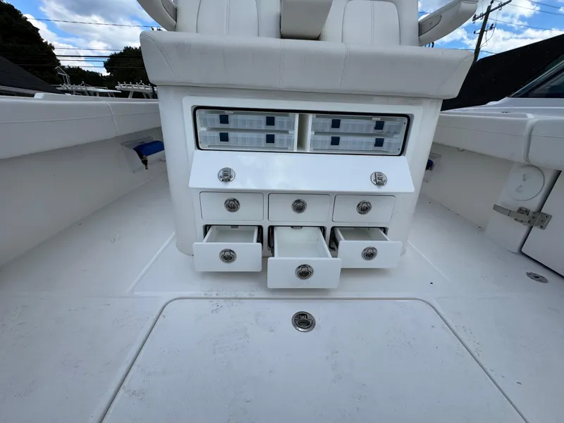 Slide: The Image of 2025 Regulator 31 boat with open storage compartments and drawers on deck. - 8
