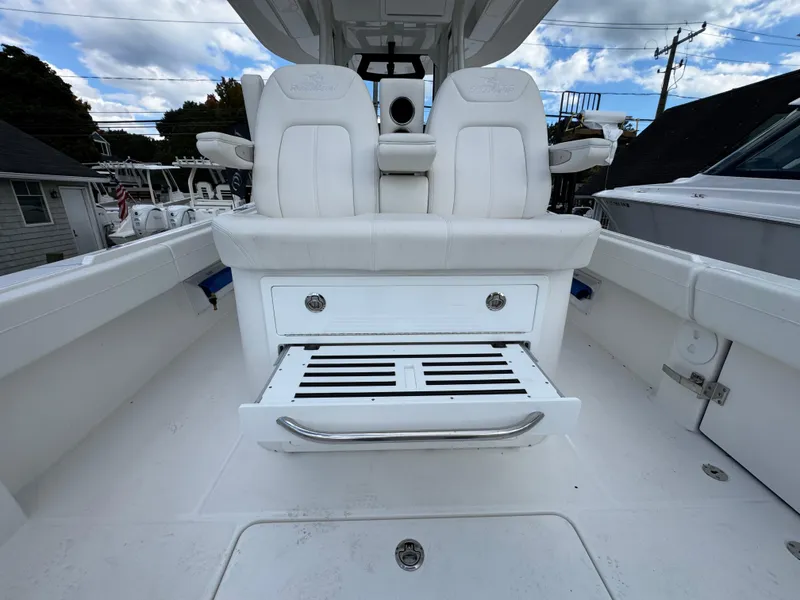 Slide: The Image of 2025 Regulator 31 boat interior with white seating and storage compartment. - 9