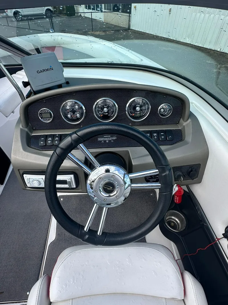 Slide: The Image of Steering wheel and dashboard of 2011 Regal 2100 Bowrider boat with Garmin device. - 12