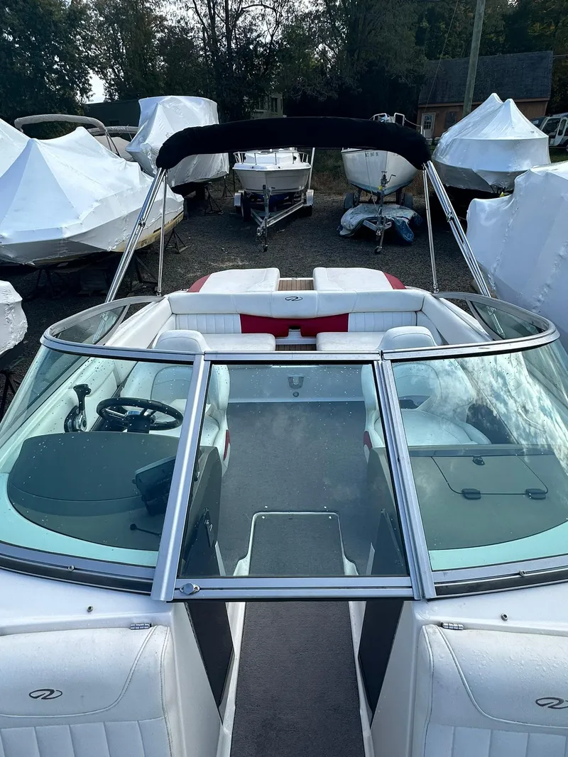 Slide: The Image of 2011 Regal 2100 Bowrider boat with sleek design and spacious seating. - 14