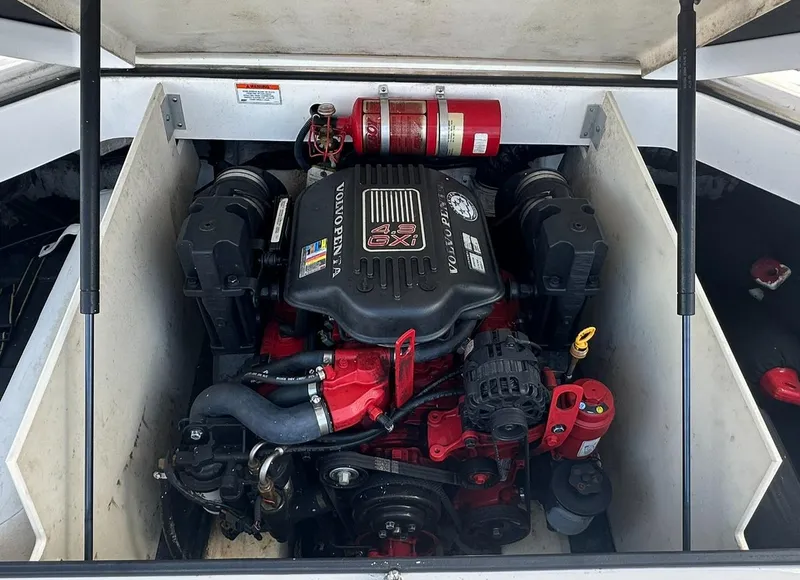 Slide: The Image of 2011 Regal 2100 Bowrider engine compartment with Volvo Penta engine and fire extinguisher. - 16