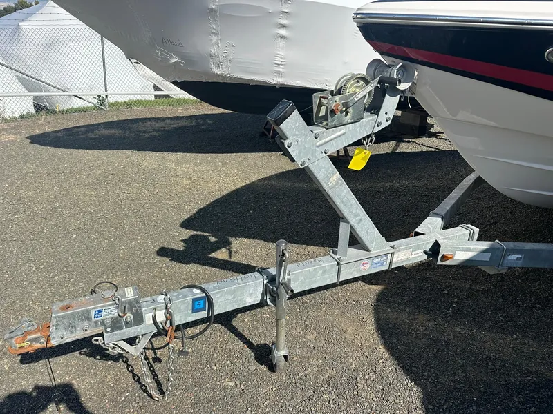 Slide: The Image of 2011 Regal 2100 Bowrider on a trailer, parked outdoors. - 21