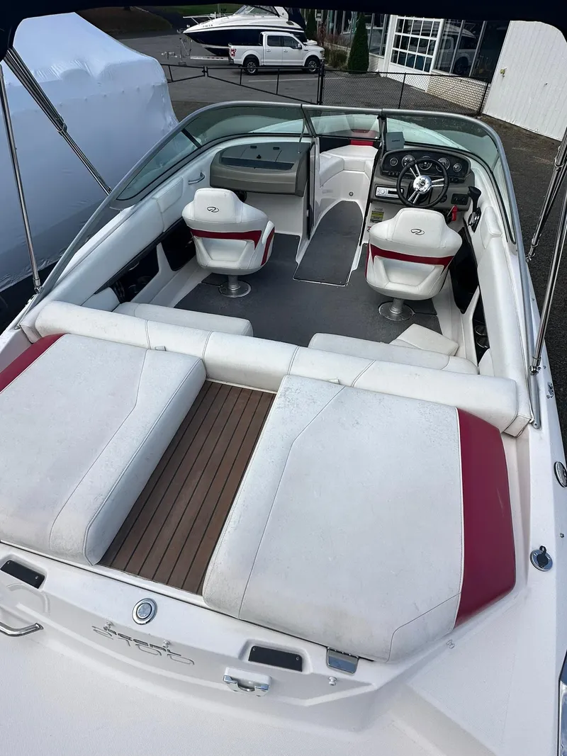 Slide: The Image of 2011 Regal 2100 Bowrider boat interior with white and red seating. - 4