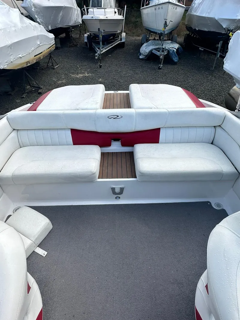 Slide: The Image of 2011 Regal 2100 Bowrider boat interior with white and red seating. - 7
