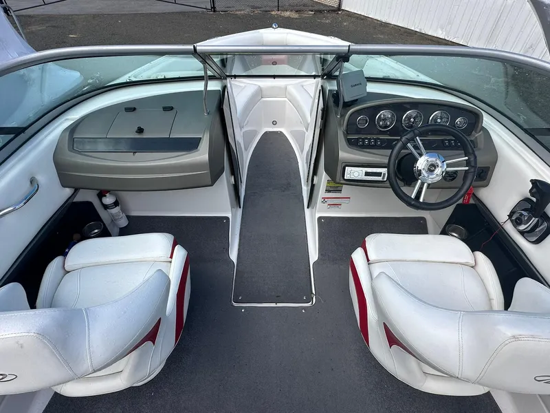 Slide: The Image of 2011 Regal 2100 Bowrider interior with white seats and modern dashboard. - 8
