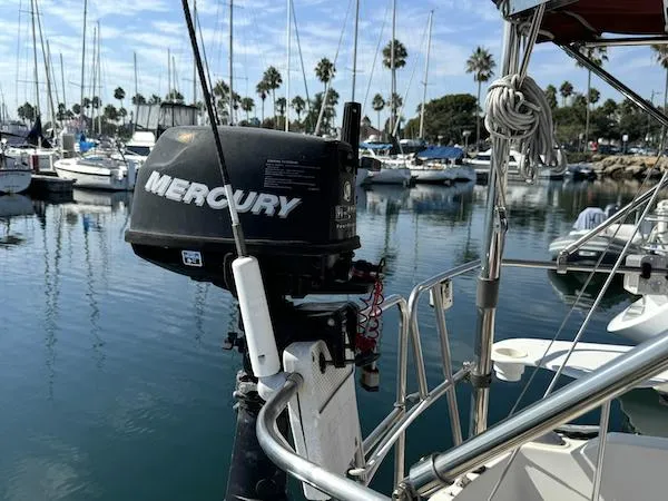Slide: The Image of Catalina 30 sailboat with Mercury outboard motor in a marina, 1983 model. - 2