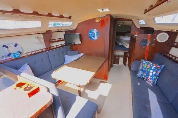 Slide: The Image of Interior of 1983 Catalina 30 sailboat with cozy seating and nautical decor. - 3