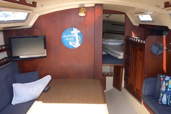 Slide: The Image of Interior of 1983 Catalina 30 sailboat with cozy seating and wooden decor. - 6