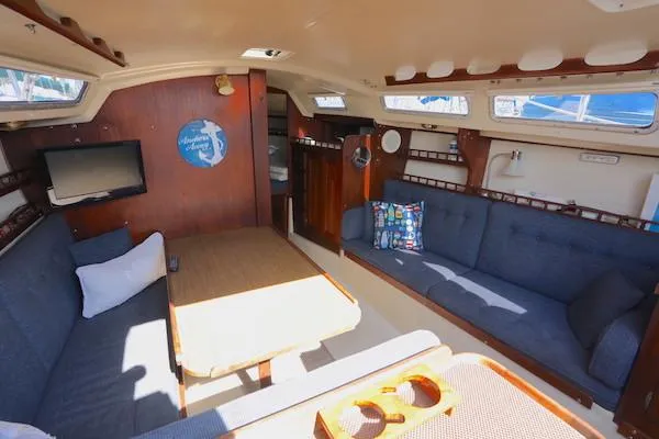 Slide: The Image of Interior of a 1983 Catalina 30 sailboat with cozy seating and nautical decor. - 7