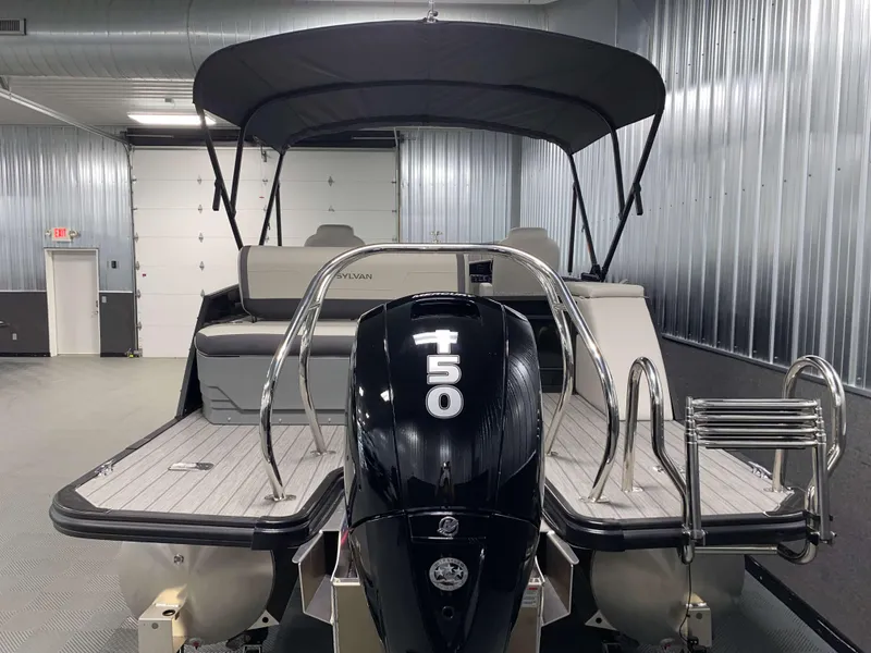 Slide: The Image of 2025 Sylvan Mirage X3 CLZ DH Tritoon with Mercury 150HP engine in a showroom. - 20