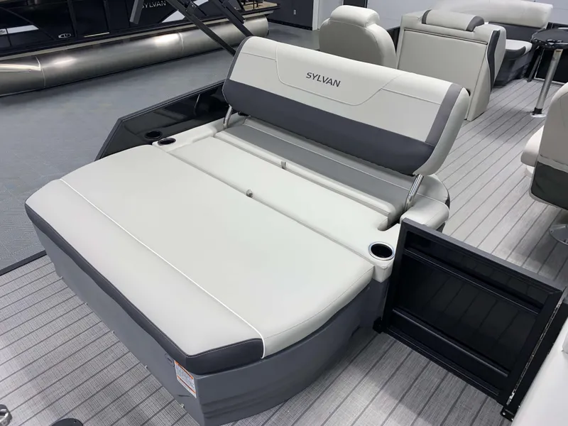Slide: The Image of 2025 Sylvan Mirage X3 CLZ DH Tritoon boat interior with gray seating and cup holders. - 4
