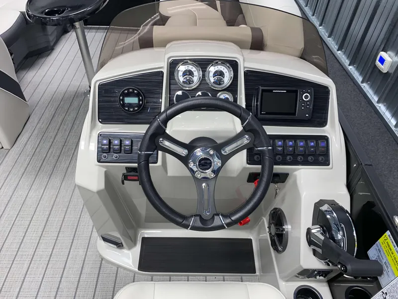 Slide: The Image of 2025 Sylvan Mirage X3 CLZ DH Tritoon dashboard with Mercury 150HP controls and gauges. - 9