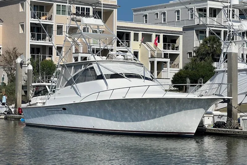 The Image of 1999 Ocean Yachts EXPRESS docked near waterfront buildings. - 0