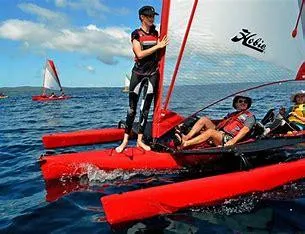 Slide: The Image of 2023 Hobie Mirage Tandem Island sailing on open water with crew. - 3