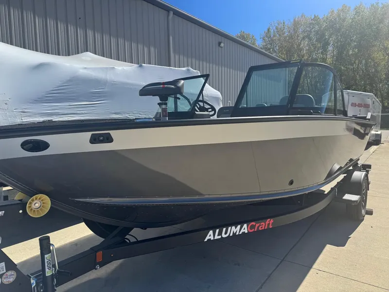 The Image of 2025 Alumacraft Trophy 185X SC Rotax S boat on trailer, outdoor setting. - 0