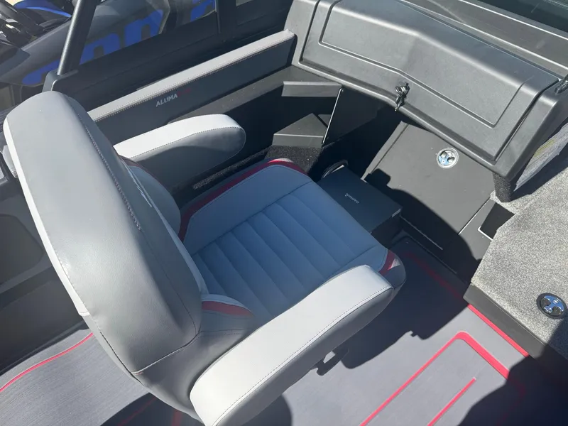 Slide: The Image of 2025 Alumacraft Trophy 185X SC Rotax S interior with gray and red seating. - 13