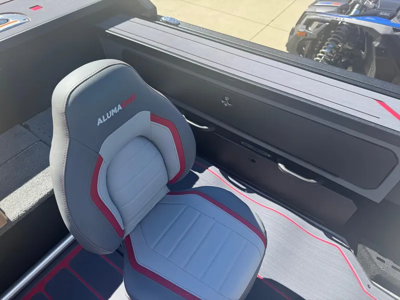 Slide: The Image of 2025 Alumacraft Trophy 185X SC Rotax S boat interior with gray and red seating. - 15