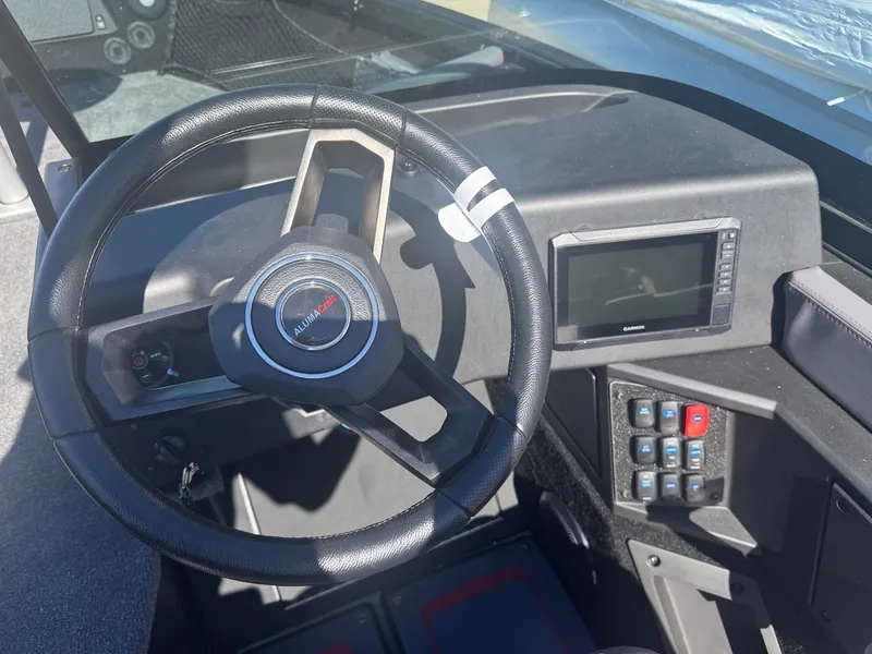 Slide: The Image of 2025 Alumacraft Trophy 185X SC Rotax S dashboard with steering wheel and control panel. - 21