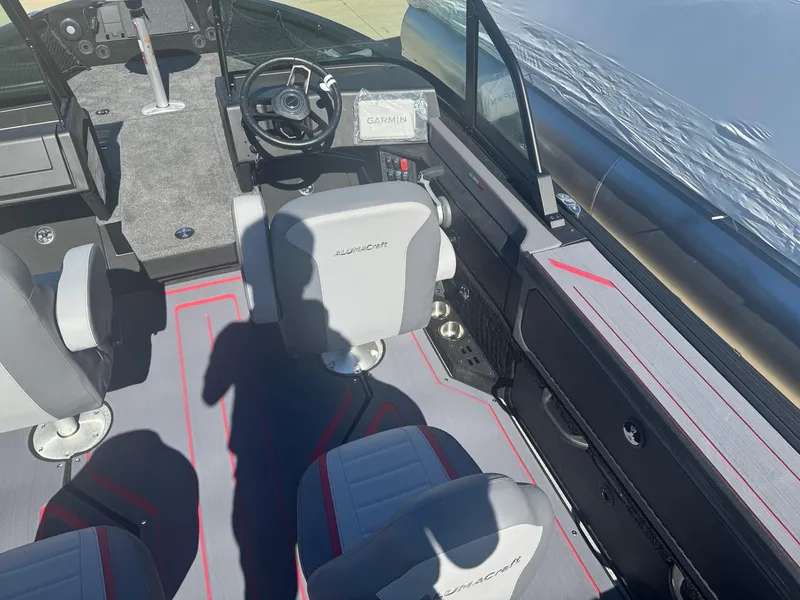 Slide: The Image of 2025 Alumacraft Trophy 185X SC Rotax S boat interior with modern seating and steering console. - 23
