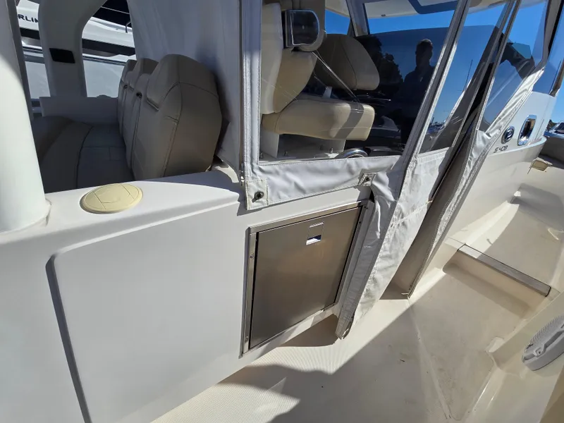 Slide: The Image of 2018 Pursuit S 408 Sport boat interior with seating and storage. - 14