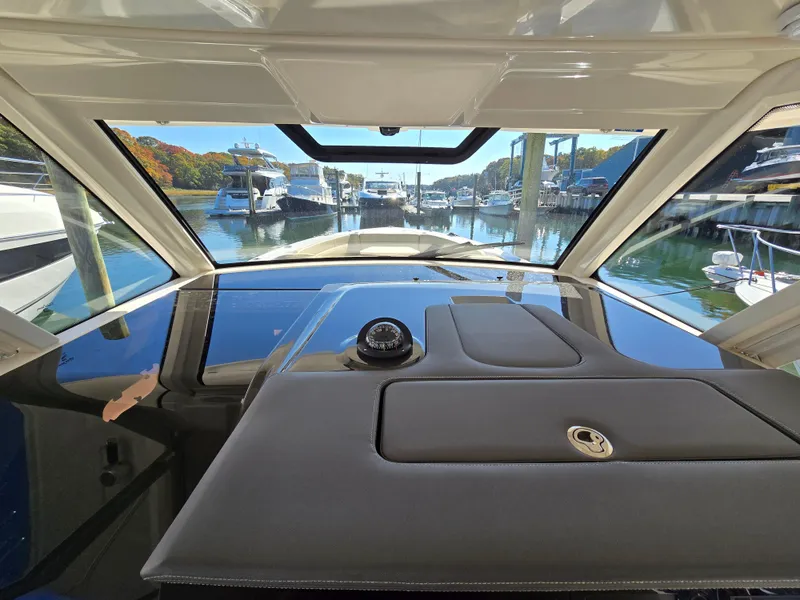 Slide: The Image of Interior view of 2018 Pursuit S 408 Sport boat at marina. - 16