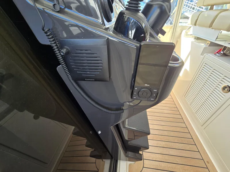 Slide: The Image of 2018 Pursuit S 408 Sport boat dashboard with communication equipment and controls. - 23