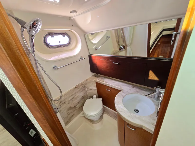 Slide: The Image of Luxurious bathroom in 2018 Pursuit S 408 Sport boat with modern fixtures and wood accents. - 28