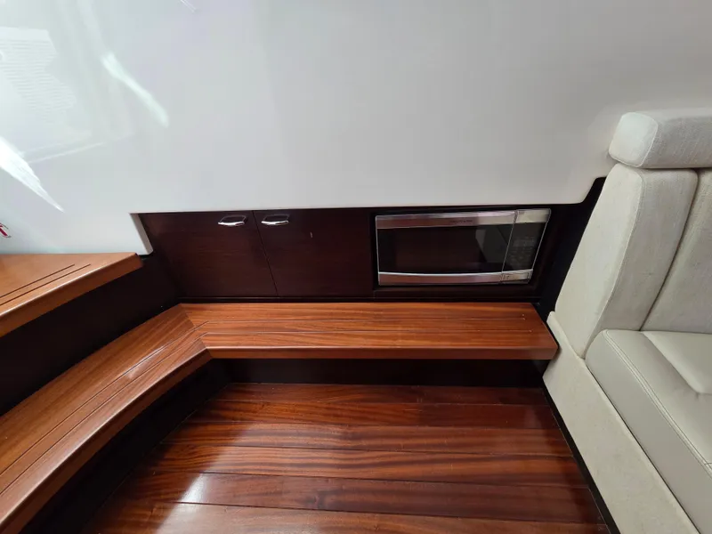 Slide: The Image of Luxurious interior of 2018 Pursuit S 408 Sport boat with wooden flooring and seating. - 30