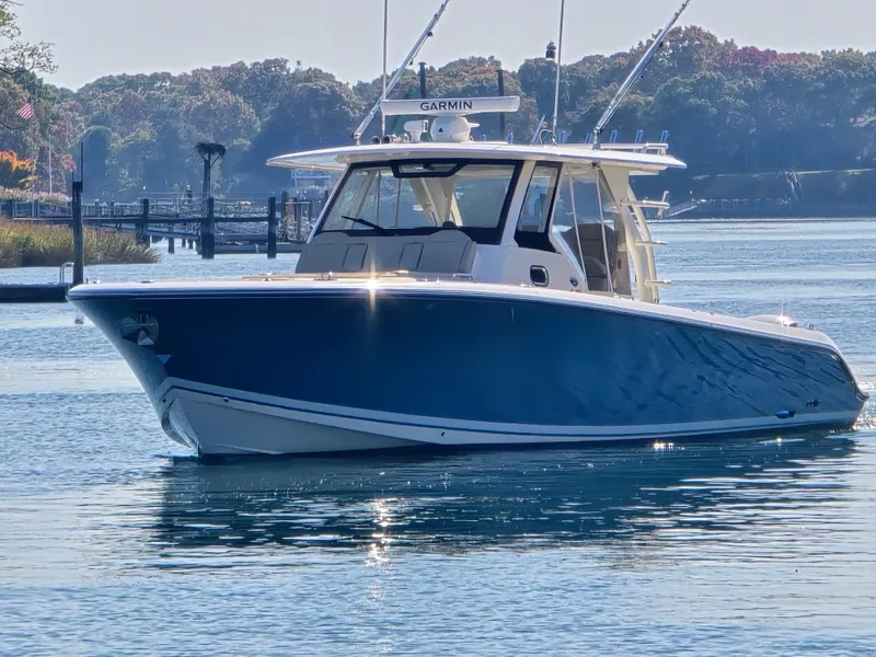 Slide: The Image of 2018 Pursuit S 408 Sport boat on calm water, sunny day. - 6