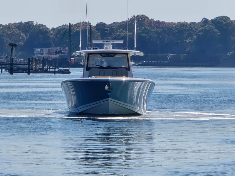 Slide: The Image of 2018 Pursuit S 408 Sport boat on calm water, front view. - 7