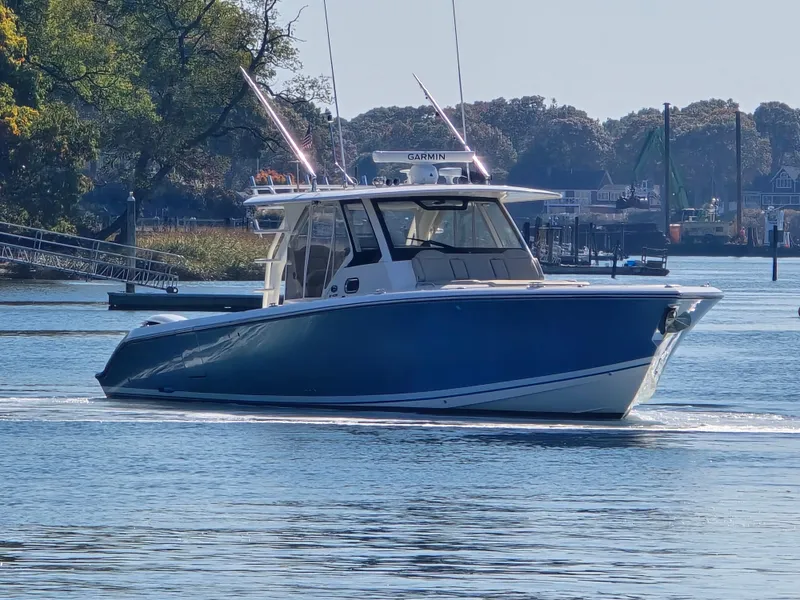 Slide: The Image of 2018 Pursuit S 408 Sport boat cruising on a calm river. - 8