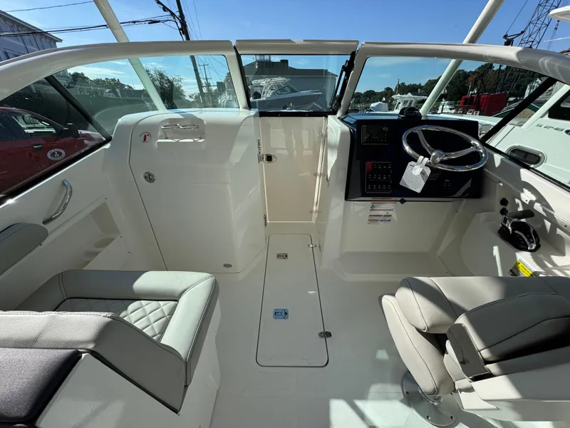 Slide: The Image of 2025 Pursuit DC 246 Dual Console boat interior with modern helm and seating. - 12