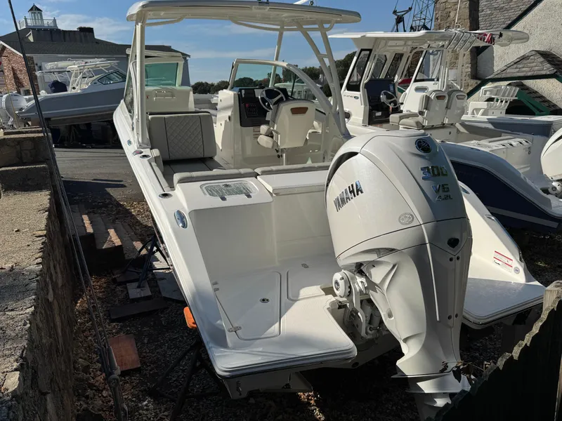 Slide: The Image of 2025 Pursuit DC 246 Dual Console boat with Yamaha 300 engine, docked outdoors. - 14