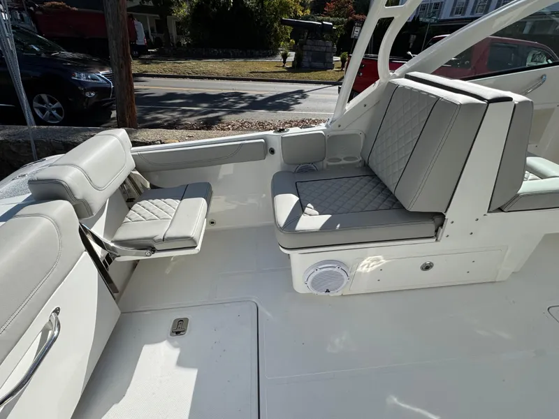 Slide: The Image of 2025 Pursuit DC 246 Dual Console boat interior with gray seating and modern design. - 5